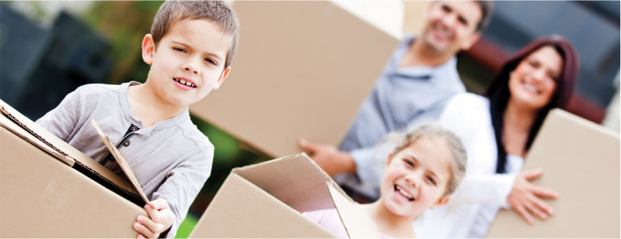 photo of a family smiling while moving their packaged home items