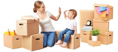 photo of a mother with her baby son sitting around their packaged home items