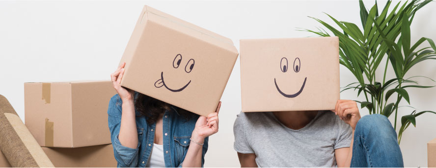 photo of a lovely couple with boxes that have smiling faces drawn on them