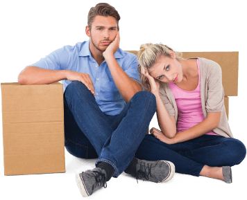 image of a tired couple after packing boxes